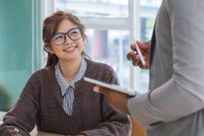 Cheerful English Teacher Discussing with Students